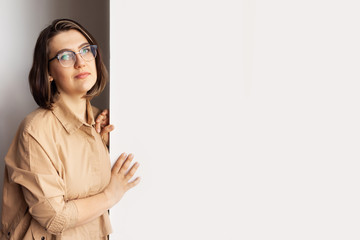 Portrait of stylish intellectual credible woman with white place for information. Nice smile, glasses. The concept of a doctor, psychologist, psychiatrist, blogger, designer.