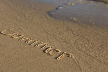 Fototapeta na wymiar word in the sand