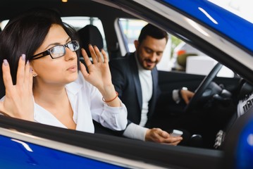 Young business people working together while traveling by a car.