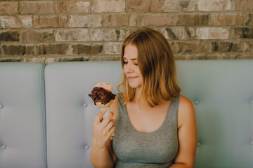 retrato de mujer sonriente tomando un helado en una heladería en verano