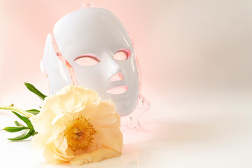 Color therapy mask glowing red on, peony