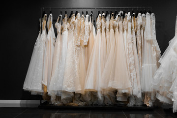 Wedding dresses made of silk chiffon, tulle and lace. Beautiful White cream bridal dress on hangers...