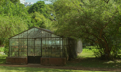 Old abandoned greenhouse surrounded by nature. A beautiful garden in the countryside with a nice historical building. It´s located in Buenos Aires, Argentina.