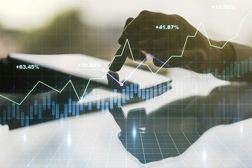 Abstract creative financial graph with finger clicks on a digital tablet on background, forex and...