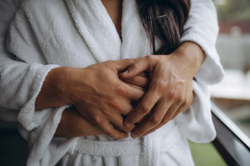 Closeup of a young man hugging a woman