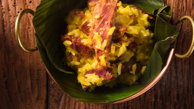 dried meat with rice in an old copper pot - Traditional bahia food with smoke. Top view.
