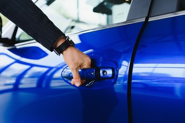 Male hand on the shift lever of the transmission in the car