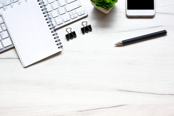 White desk office with laptop, smartphone and other work supplies with cup of coffee. Top view with...