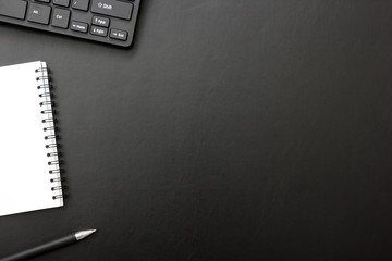 Black desk office with laptop, smartphone and other work supplies with cup of coffee. Top view with copy space for input the text. Designer workspace on desk table essential elements on flat lay