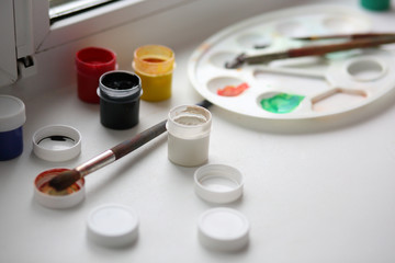 gouache and palette with brushes for drawing on the window