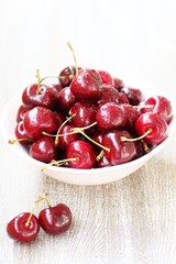 juicy ripe sweet cherries in a cup. close-up, blurred focus. copy space