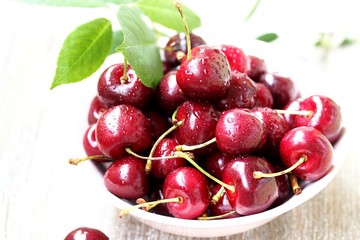 juicy ripe sweet cherries in a cup. close-up, blurred focus. copy space