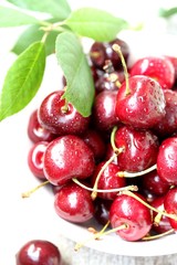 juicy ripe sweet cherries in a cup. close-up, blurred focus. copy space