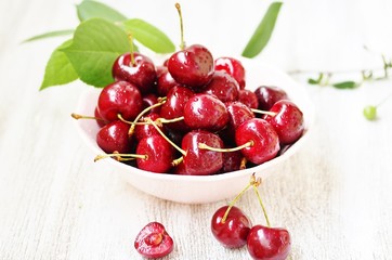 juicy ripe sweet cherries in a cup. close-up, blurred focus. copy space