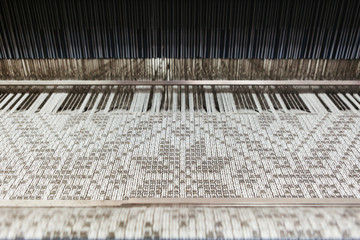 Textile looms weaving linen yarn in a textile mill. Short focus.
