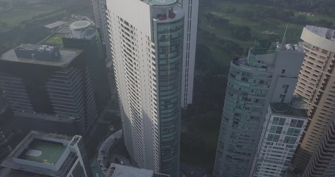 Ungraded, Aerial flight over helipad towards high rise buildings next to park, Drone, 4K
