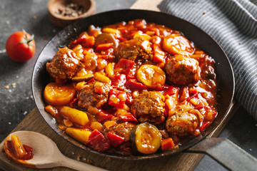 Meatballs with vegetables served on pan