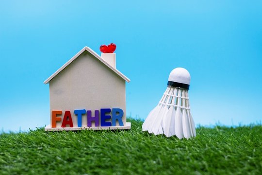 Happy Father's Day For Badminton Player With Shuttlecock And House On Green Grass