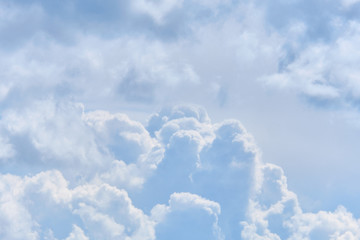 Thick white clouds in the sky at the level of an airplane in flight.