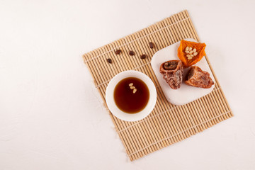Sujeonggwa is a traditional Korean cold drink. Dark reddish brown in color, it is made from gotgam (dried persimmon) and is often garnished with pine nuts