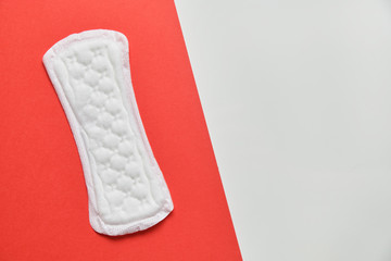 Female laying on a red and white background. Top view. Copy space.