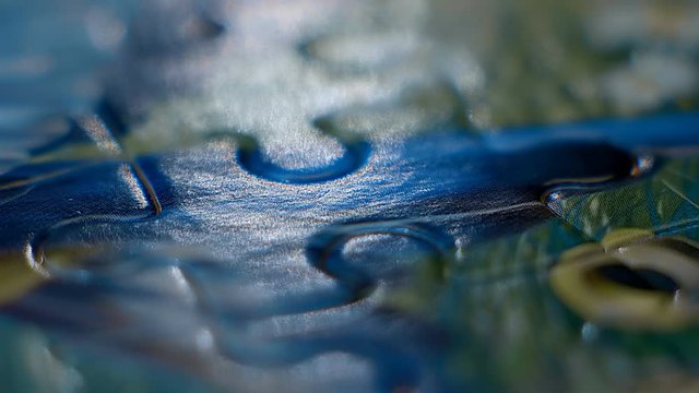 Set the last puzzle element to the place highlighted below. Macro. Closeup. Shallow depth of field