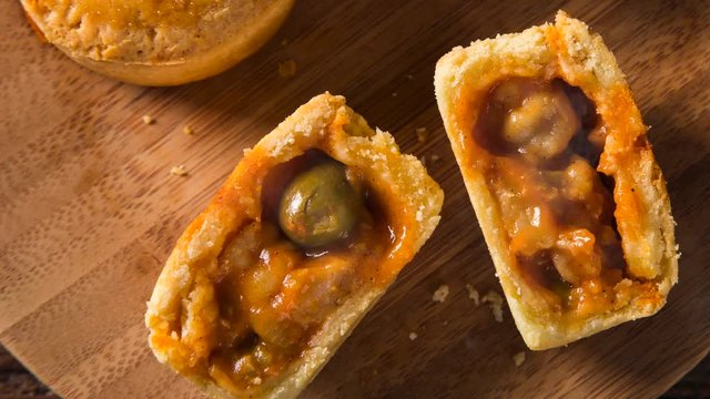 Empada Brazilian snack with smoke. pie with shrimp on wood plate on wooden background