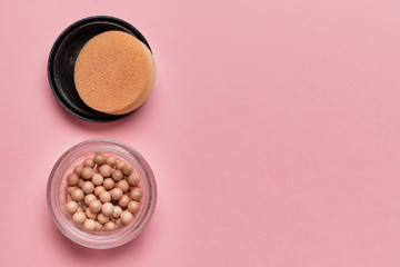 Powder on a pink background with copy space.