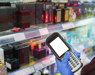 barcode scanner in hand in rubber gloves checks the price of products in the supermarket. close-up view © Aleksandr Kolesnikov