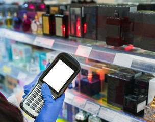 barcode scanner in hand in rubber gloves checks the price of products in the supermarket. close-up view