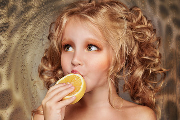 close up portrait of beautiful little girl with orange