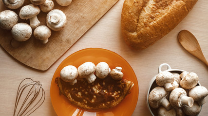 homemade food. cooking at home, mushrooms and scrambled eggs for breakfast. loaf of bread