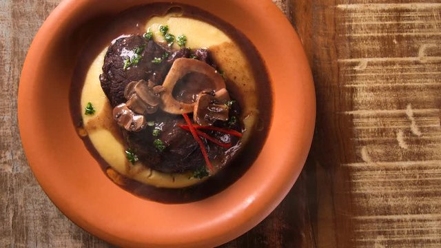 Ossobuco with polenta. Top view with smoke.