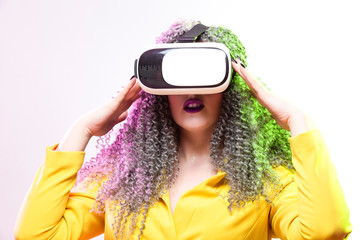 Virtual Reality Concepts. Portrait of caucasian Girl With Curly Colorful Hair Playing With VR (Virtual Reality) Helmet.