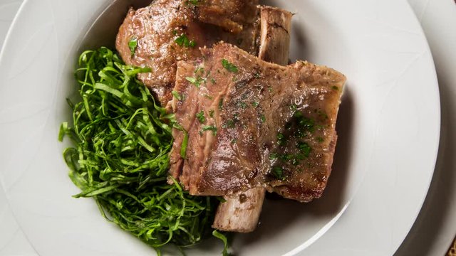 Grilled ribs with cabbage - Traditional brazilian food Costela com couve. Top view with smoke.