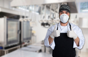 Fototapeta na wymiar Chef making thumbs up with mouth mask and latex gloves