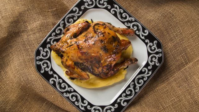 Little Chicken dish with polenta on wood background. Top view with smoke.