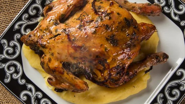 Little Chicken dish with polenta on wood background. Top view with smoke.