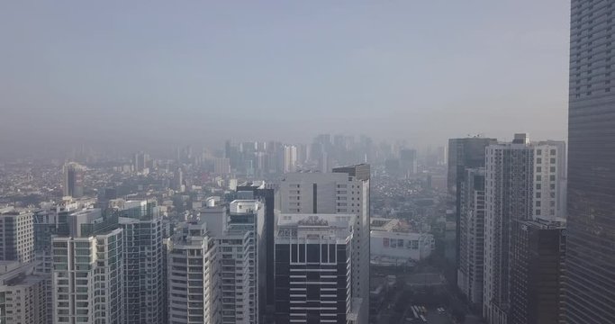 Ungraded, Morning aerial flight towards skyscrapers in metropolitan city. Drone, 4K