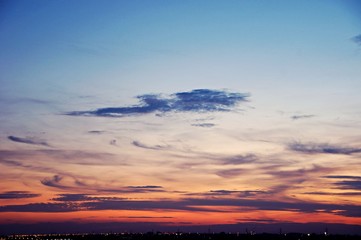 Fototapeta premium The atmosphere , Beautiful sky painted by the sun leaving bright golden shades . Dense clouds in twilight sky in winter evening . Evening sky scene with golden light from the setting sun