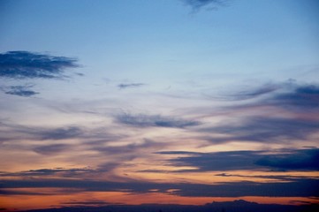 Obraz premium The atmosphere , Beautiful sky painted by the sun leaving bright golden shades . Dense clouds in twilight sky in winter evening . Evening sky scene with golden light from the setting sun