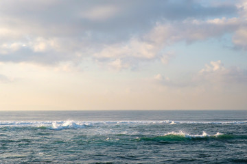 Fototapeta premium Delicate colors of dawn over the ocean. A minimalistic view of the tropical sea with beautiful pastel colors. For design and networking