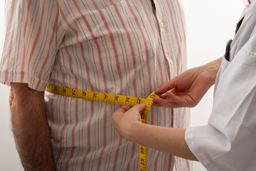 young female doctor is measuring senior man's body circumference 