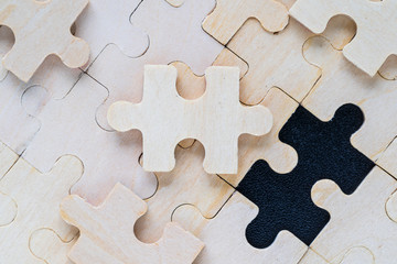 wooden jigsaw puzzle pieces on black background