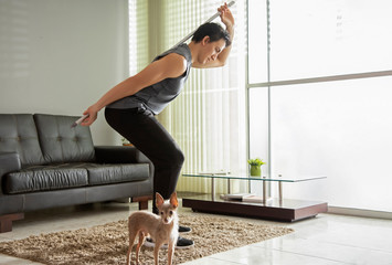 man doing back exercise with a broomstick