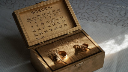 Wooden box with sunscha and ring trades. 