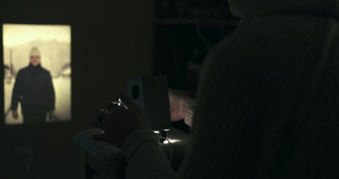 Closeup Of A Person Projecting Photograph Slides, Photographer.