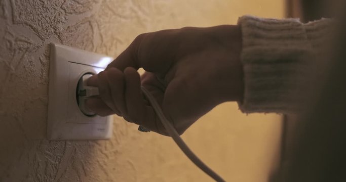 Closeup Of A Power Cord Plugged Into A Electrical Outlet.