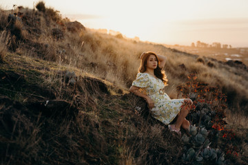 Beautiful asian woman  looking at view in field with sunset at New zealand countryside near the outskirts of Christchurch.