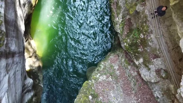 Flying up in the Areuse canyon with green water and a look at the drone pilot